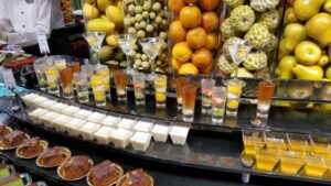 a table with glasses of drinks and fruit